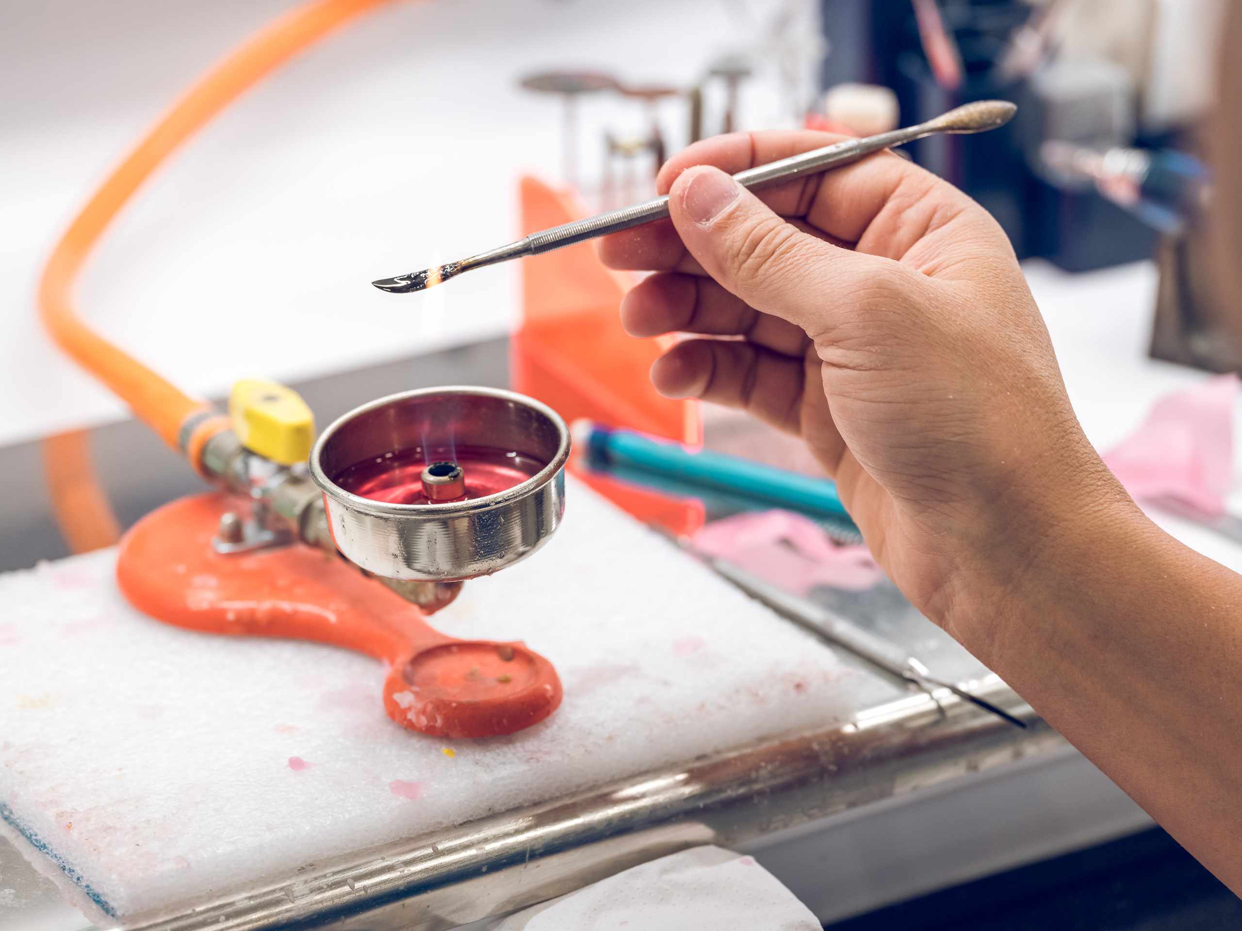 Technician working with wax and a small flame